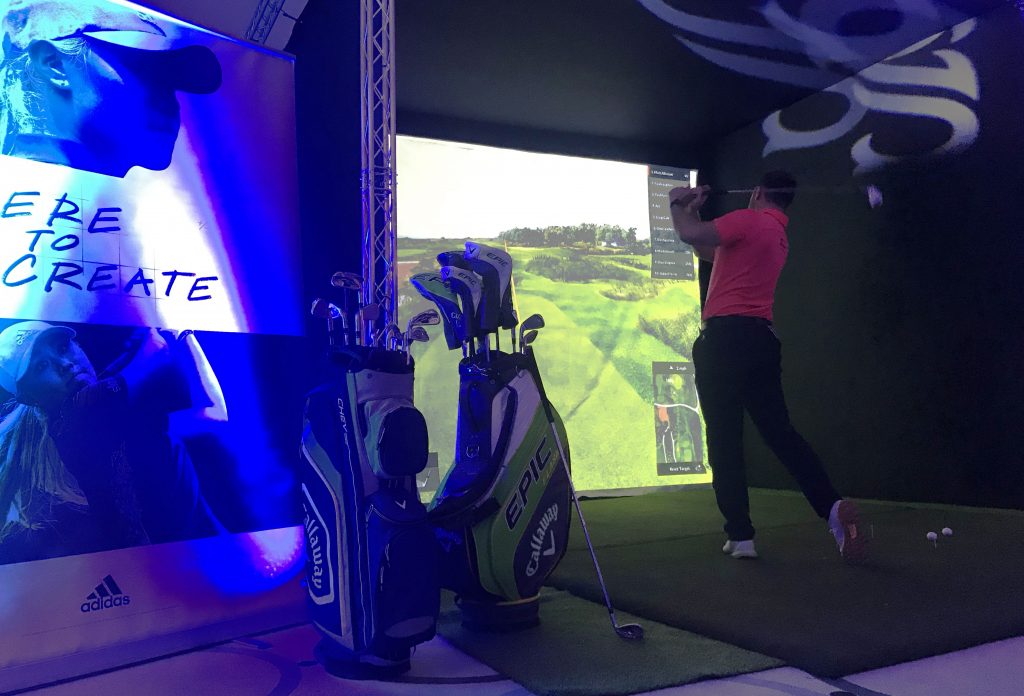 hire a golf simulator hire. Golfer demonstrating an Indoor golf simulator hire for events.